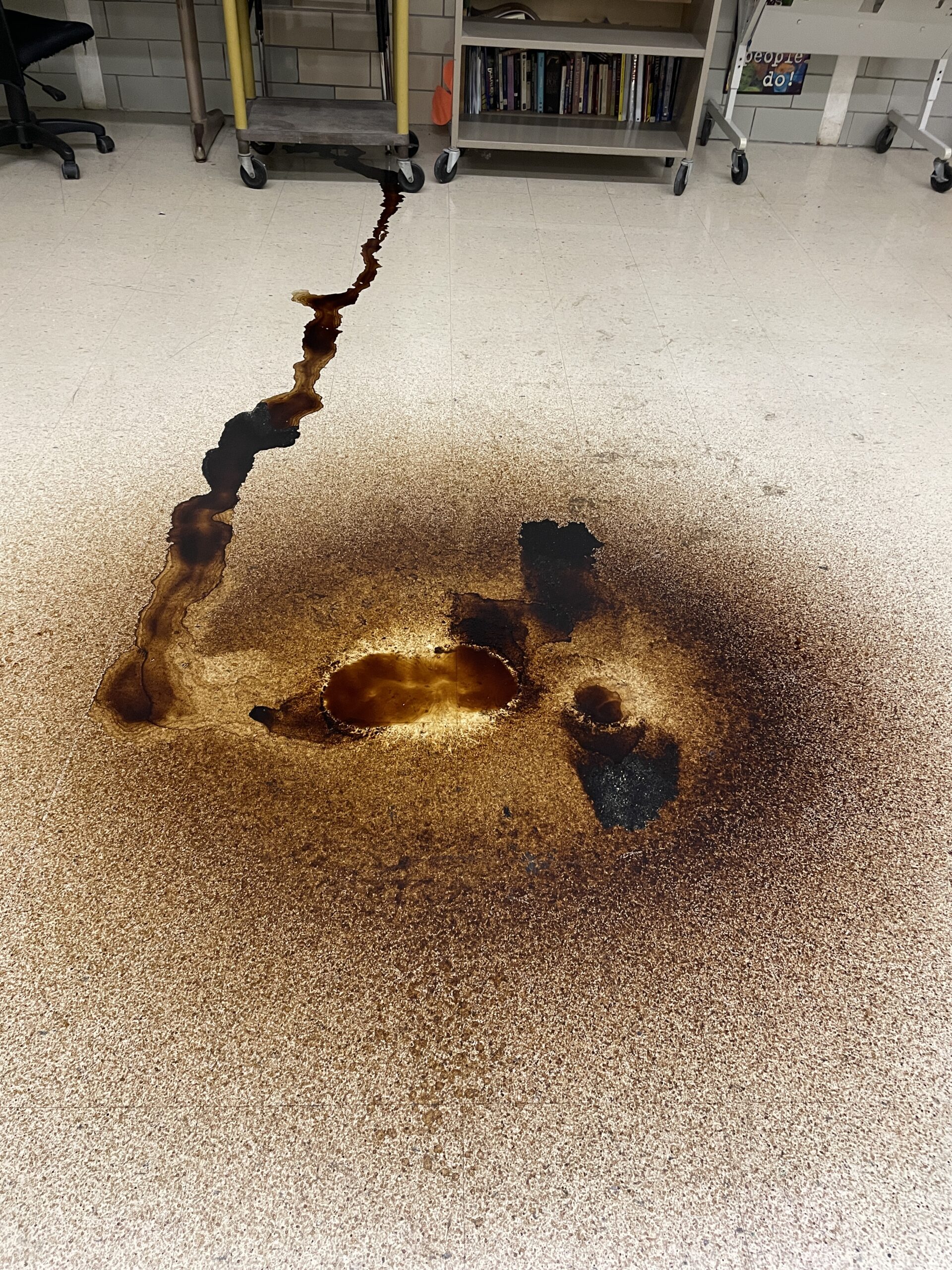 Puddles on Learwood classroom floor from ceiling leak